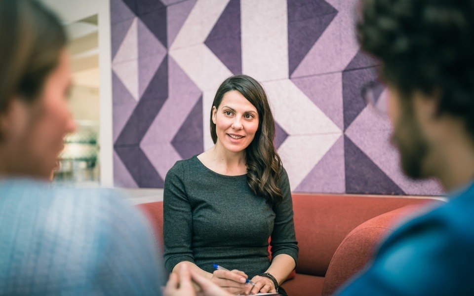 Woman answering questions from an interview panel for a new job